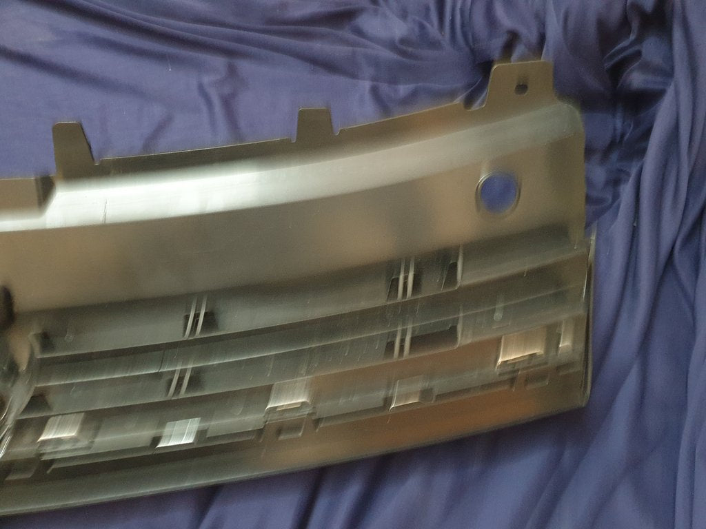 Volkswagen Polo 2018, 2019, 2020, 2021, 2022, 2023 Radiator Grille - Deep abrasion, Wear and Tear, Broken badge