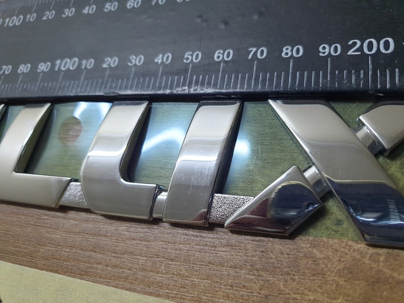 Original Used Toyota Hilux Front Door 'HILUX' Badge